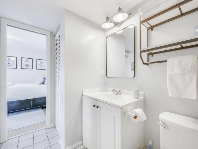 bathroom featuring tile patterned floors, toilet, and vanity