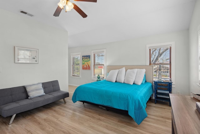 bedroom with visible vents, baseboards, a ceiling fan, and wood finished floors