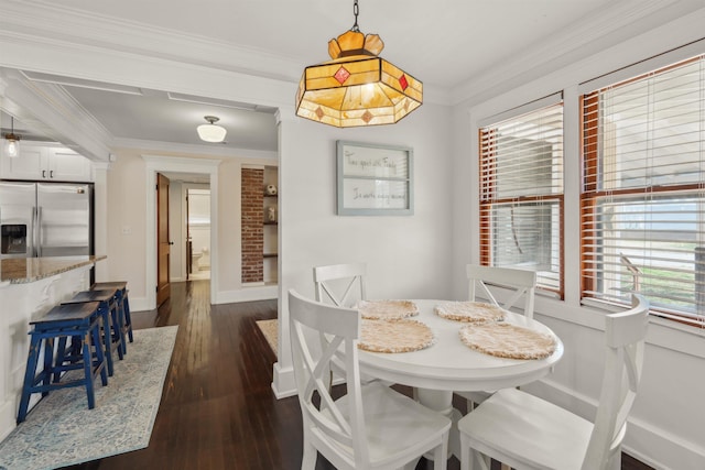 dining space featuring baseboards, ornamental molding, and dark wood finished floors