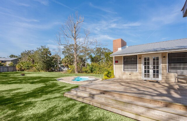 exterior space with a yard, french doors, and an outdoor pool