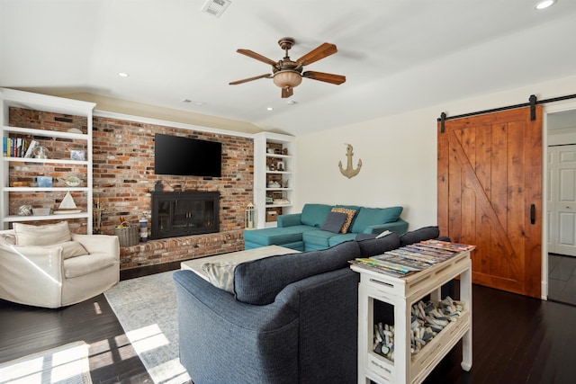 living room featuring visible vents, a barn door, dark wood finished floors, and vaulted ceiling