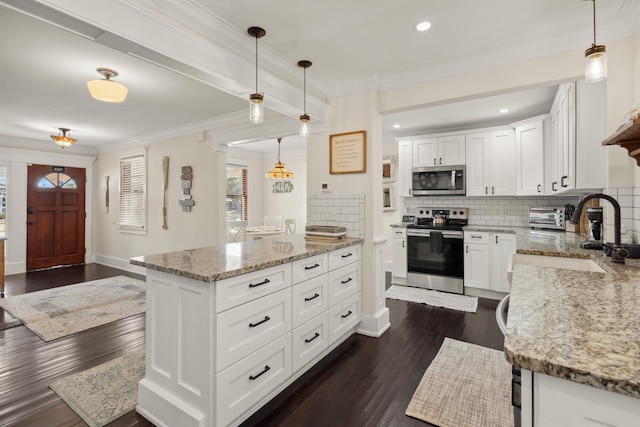 kitchen with light stone counters, dark wood finished floors, stainless steel appliances, crown molding, and tasteful backsplash