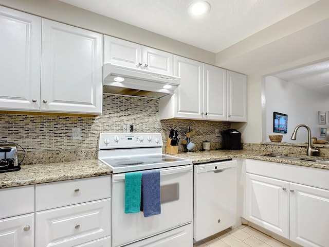4 Ocean Trace Rd Unit 123, Saint Augustine, FL 32080 - kitchen featuring white appliances, under cabinet range hood, backsplash, and white cabinetry