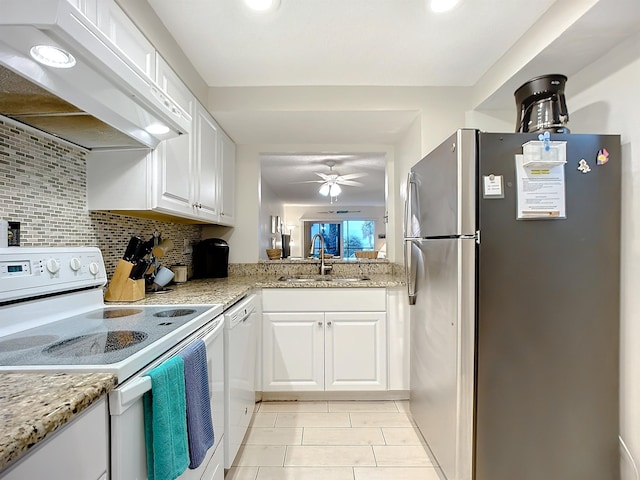 4 Ocean Trace Rd Unit 123, Saint Augustine, FL 32080 - kitchen with white appliances, extractor fan, white cabinetry, light tile patterned flooring, and ceiling fan