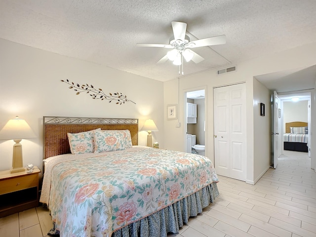 4 Ocean Trace Rd Unit 123, Saint Augustine, FL 32080 - bedroom featuring a textured ceiling, a closet, connected bathroom, and ceiling fan