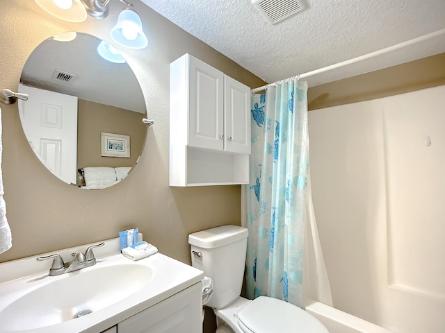 4 Ocean Trace Rd Unit 123, Saint Augustine, FL 32080 - bathroom featuring vanity, a textured ceiling, and shower / bath combo