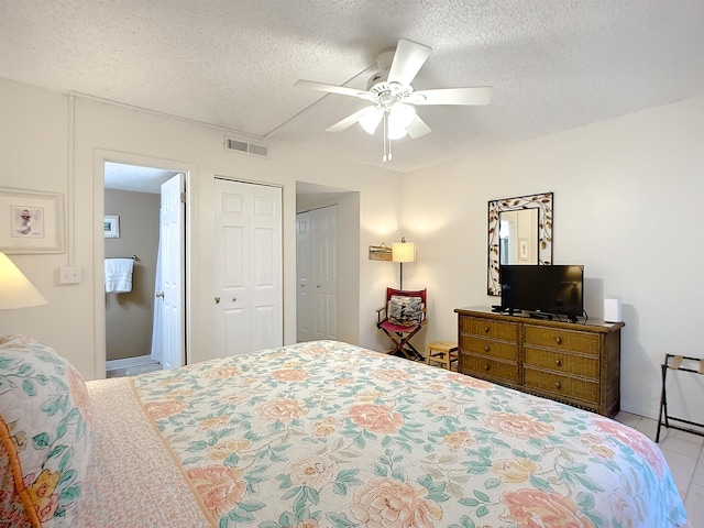 4 Ocean Trace Rd Unit 123, Saint Augustine, FL 32080 - bedroom with a textured ceiling, a ceiling fan, and tile patterned floors