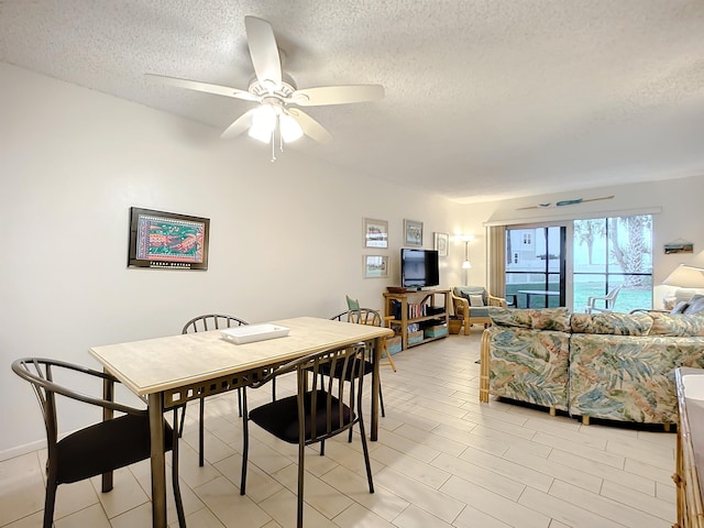 dining room featuring a textured ceiling and ceiling fan