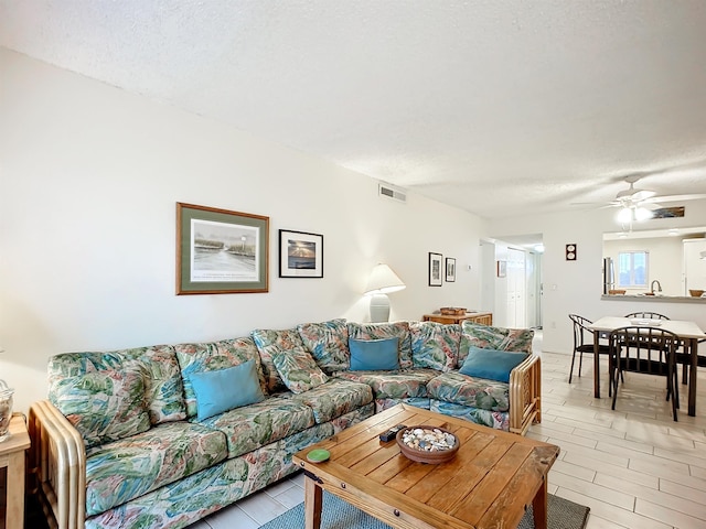 4 Ocean Trace Rd Unit 123, Saint Augustine, FL 32080 - living area featuring a ceiling fan and a textured ceiling