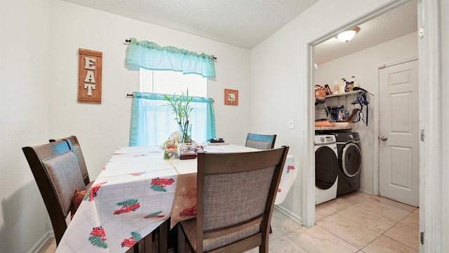 tiled dining room featuring washer and dryer and a textured ceiling