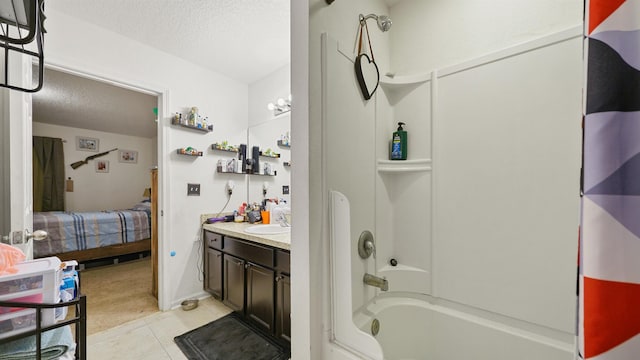 bathroom with tile patterned flooring, vanity, shower / bath combination, and a textured ceiling