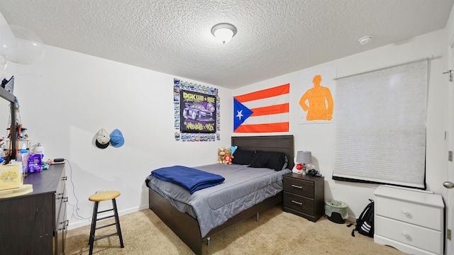 bedroom featuring a textured ceiling and light carpet