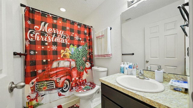 bathroom with tile patterned flooring, vanity, and toilet