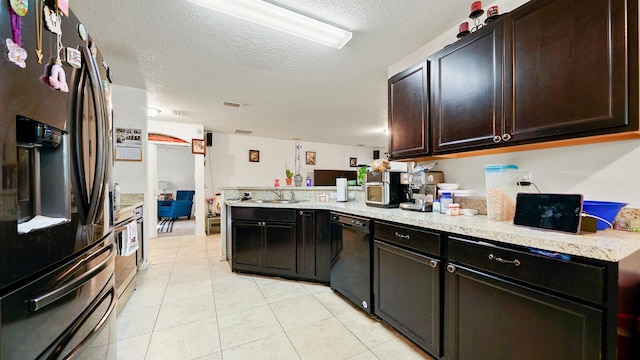 kitchen with sink, dark brown cabinets, light tile patterned flooring, kitchen peninsula, and stainless steel appliances