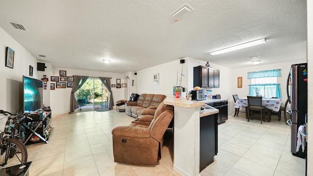 tiled living room with a textured ceiling