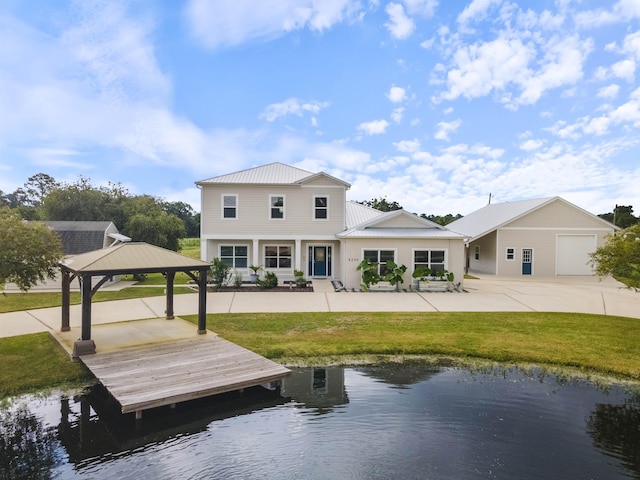 rear view of property featuring a gazebo and a water view