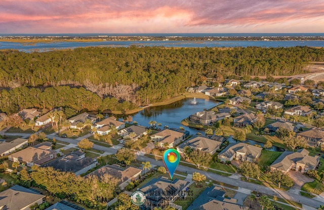 aerial view at dusk with a water view