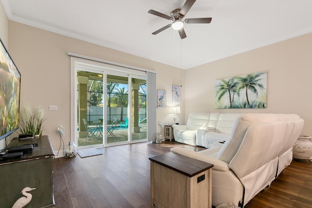 living room with dark hardwood / wood-style flooring, ceiling fan, and crown molding