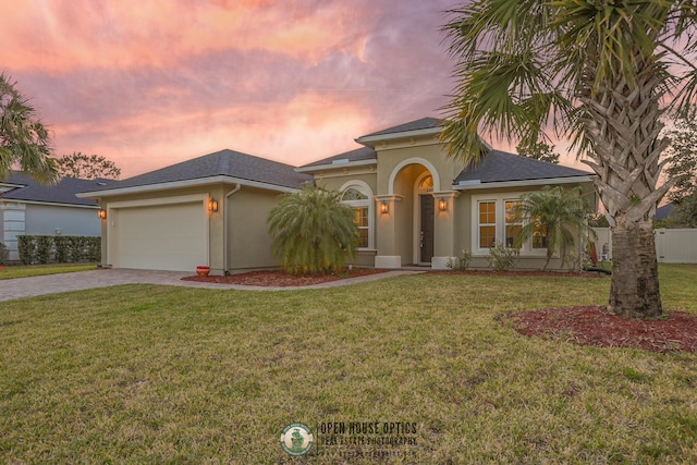 view of front of property with a lawn and a garage