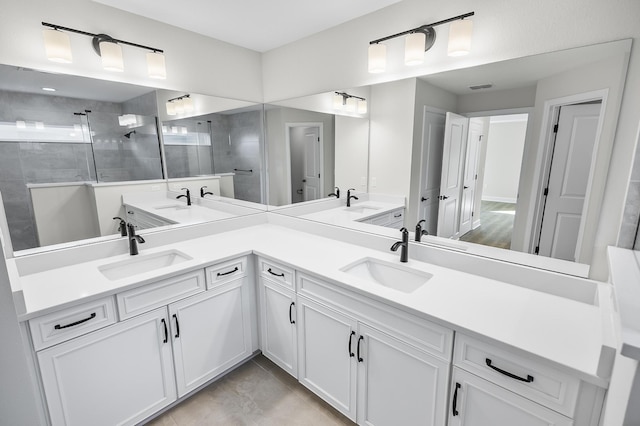 bathroom with vanity and tiled shower