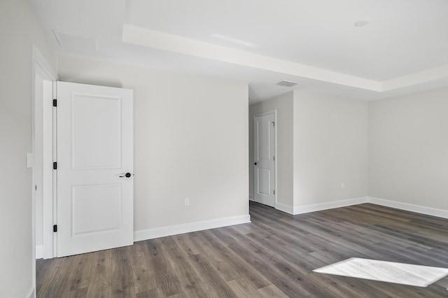 empty room with dark hardwood / wood-style flooring