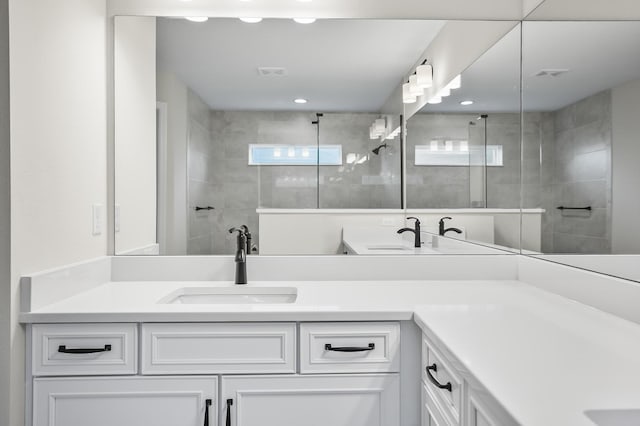 bathroom with vanity and tiled shower