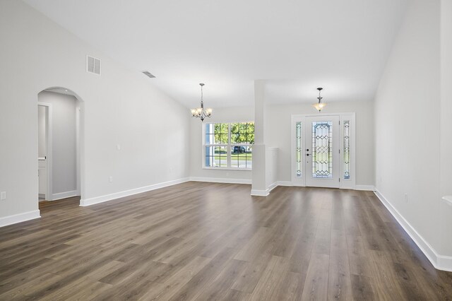 interior space with dark hardwood / wood-style floors, lofted ceiling, and a chandelier