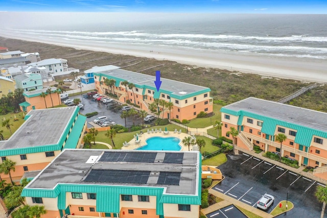 drone / aerial view with a beach view and a water view