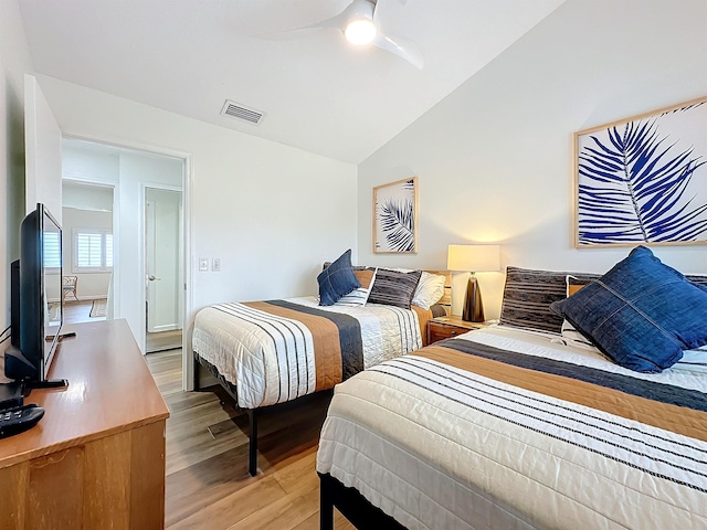 bedroom featuring ceiling fan, lofted ceiling, and light hardwood / wood-style flooring