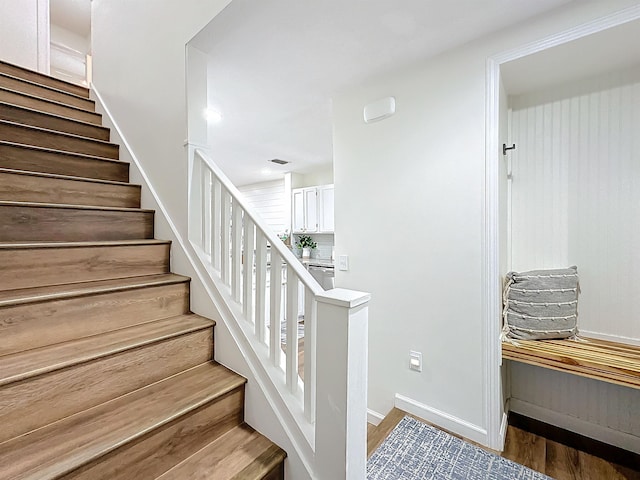 staircase with wood-type flooring