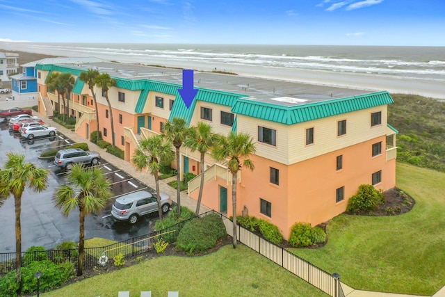 view of property featuring a water view and a view of the beach