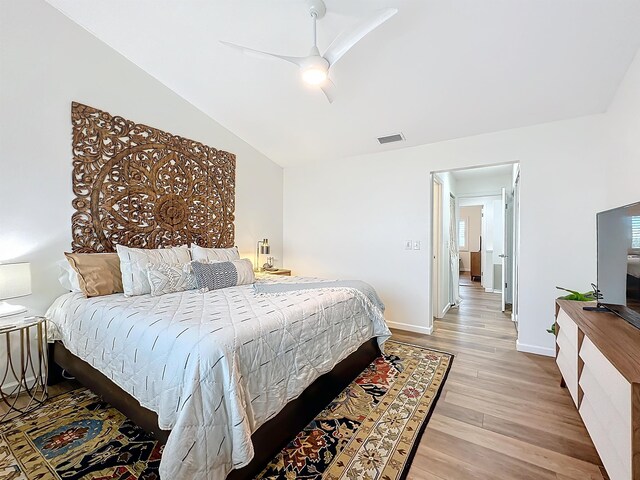 bedroom featuring ceiling fan, lofted ceiling, and light wood-type flooring