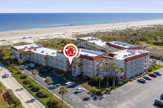 birds eye view of property with a water view and a view of the beach