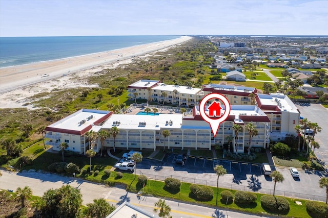 birds eye view of property with a water view and a view of the beach