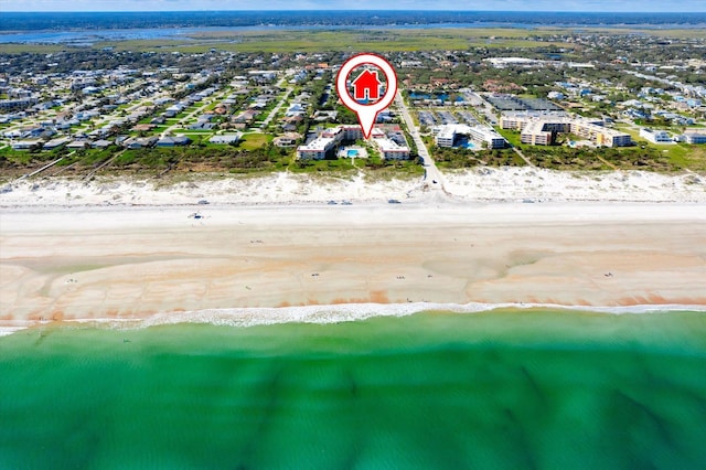 birds eye view of property with a beach view and a water view