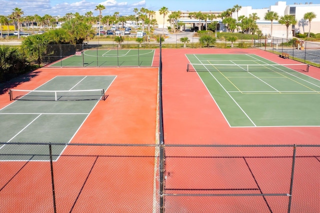 view of tennis court featuring basketball hoop