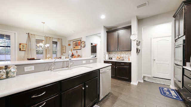 kitchen with visible vents, stainless steel appliances, a sink, and light countertops