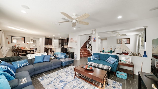 living area with stairs, a ceiling fan, and recessed lighting