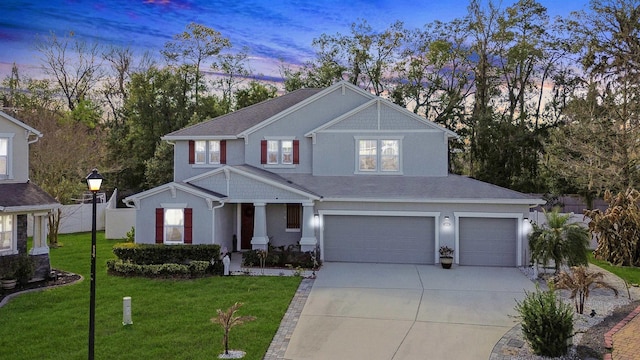 view of front of home with a garage, a front yard, driveway, and fence