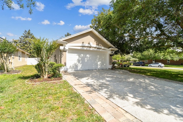 view of front facade featuring concrete driveway, a front lawn, stucco siding, and an attached garage