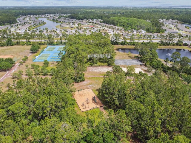 view of property location with a large body of water and a forest