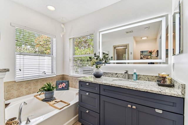 bathroom featuring a bath and vanity