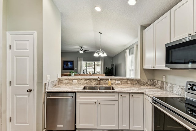 kitchen featuring appliances with stainless steel finishes, a sink, a textured ceiling, a ceiling fan, and white cabinets