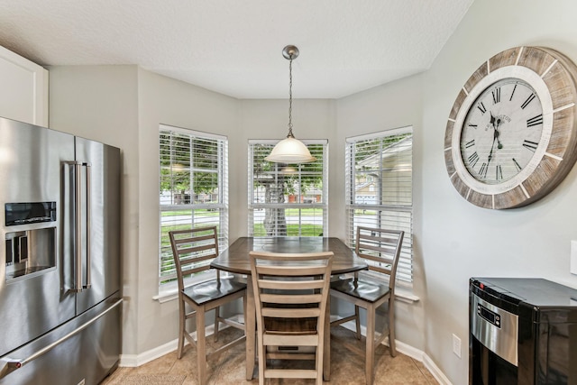 dining area featuring baseboards and a textured ceiling