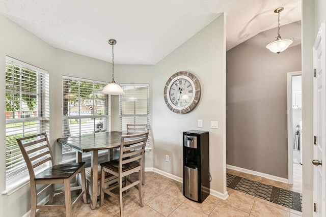 dining area with light tile patterned floors and baseboards