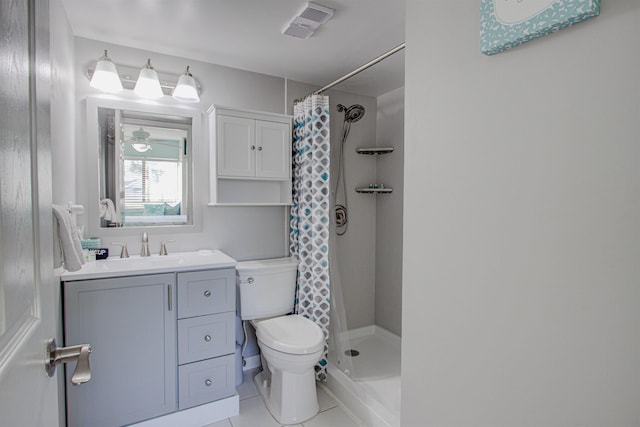 bathroom with a shower with shower curtain, vanity, toilet, and tile patterned flooring