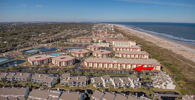 birds eye view of property featuring a beach view and a water view