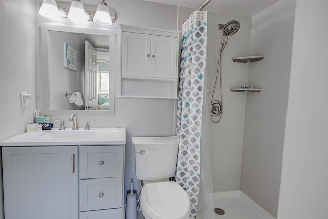 bathroom with a shower with curtain, vanity, and toilet