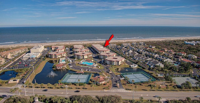 drone / aerial view with a water view and a view of the beach