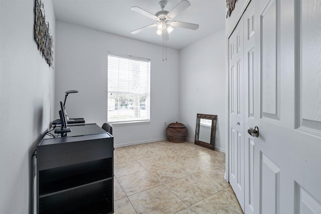 office area featuring light tile patterned flooring, baseboards, and ceiling fan